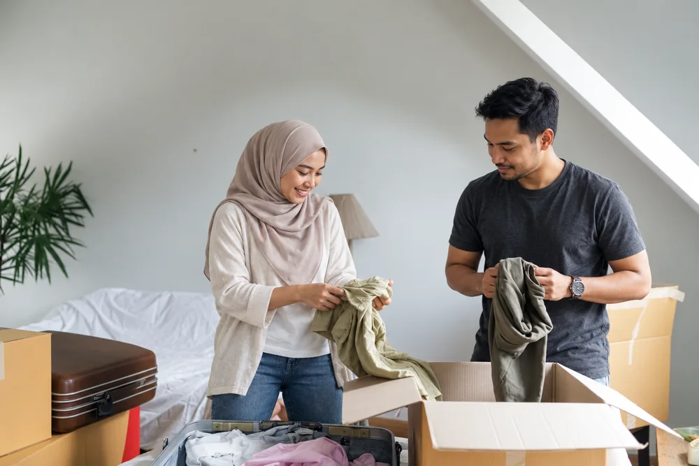 Illustration of a couple unpacking moving boxes in their new home